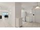 Bright kitchen with white cabinets, tile floors, stainless steel appliances, and view of living area at 3425 S Atlantic Ave # 1602, Daytona Beach, FL 32118