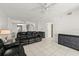 Spacious living room featuring tile floors, a ceiling fan, and a stylish sofa at 3425 S Atlantic Ave # 1602, Daytona Beach, FL 32118