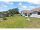 Large backyard with manicured lawn, rock garden, and partial fencing, great for outdoor activities at 35 China Moon Dr, Ormond Beach, FL 32174