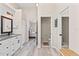 Hallway view featuring a modern bathroom with a double vanity and glass shower at 35 China Moon Dr, Ormond Beach, FL 32174