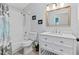 Well-lit bathroom featuring a shower-tub combo, a toilet, and a modern vanity with a framed mirror at 35 China Moon Dr, Ormond Beach, FL 32174