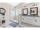 Stylish bathroom boasts double sinks, a modern glass shower, and plank flooring at 35 China Moon Dr, Ormond Beach, FL 32174