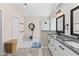 Bright bathroom with double vanity, glass shower, and linen closet for storage at 35 China Moon Dr, Ormond Beach, FL 32174