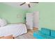 Cozy bedroom features a single bed, green walls, and a comfortable seating area at 35 China Moon Dr, Ormond Beach, FL 32174