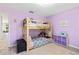 Bright bedroom with bunk beds, soft purple walls, and a cozy layout and decor at 35 China Moon Dr, Ormond Beach, FL 32174
