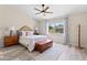 Cozy bedroom with neutral tones, a ceiling fan, and a large window for natural light at 35 China Moon Dr, Ormond Beach, FL 32174