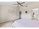 Bright bedroom with light walls, ceiling fan, and view to en-suite bathroom at 35 China Moon Dr, Ormond Beach, FL 32174