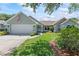 Charming single-story home featuring a well-manicured lawn and attached two-car garage at 35 China Moon Dr, Ormond Beach, FL 32174