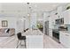 A modern kitchen features a large center island with barstool seating, stainless steel appliances and ample cabinet space at 35 China Moon Dr, Ormond Beach, FL 32174