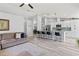 Open-concept living space featuring a modern kitchen with island seating, stainless appliances, and a comfortable sofa at 35 China Moon Dr, Ormond Beach, FL 32174