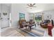 Cozy living room with comfortable seating, a ceiling fan, and large windows at 35 China Moon Dr, Ormond Beach, FL 32174