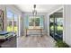 A bright and airy living space with a table, large windows with blue curtains, and a sliding glass door at 35 China Moon Dr, Ormond Beach, FL 32174