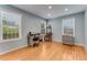 Bright bedroom featuring hardwood floors, a desk, and a classic popcorn machine at 355 Hartford Ave, Daytona Beach, FL 32118
