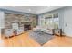 Inviting living room featuring a stone fireplace, hardwood floors, and bright natural light at 355 Hartford Ave, Daytona Beach, FL 32118