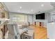 Open living room features hardwood floors, stone fireplace and a large TV at 355 Hartford Ave, Daytona Beach, FL 32118