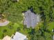 Aerial view of the house, featuring a large, grey roof, green lawn and a screened pool at 4073 N Chinook Ln, Ormond Beach, FL 32174