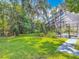 Lush backyard featuring green lawn and a screened pool, perfect for outdoor living at 4073 N Chinook Ln, Ormond Beach, FL 32174
