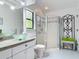 Bright bathroom with a glass bowl sink, tiled shower, and decorative accents at 4073 N Chinook Ln, Ormond Beach, FL 32174