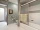 Bathroom features a shower, toilet, decorative wallpaper, handrails, and tiled floors at 4073 N Chinook Ln, Ormond Beach, FL 32174