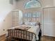Charming bedroom with unique arched window, shutter blinds, and two closets for ample storage space at 4073 N Chinook Ln, Ormond Beach, FL 32174