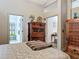 Comfortable bedroom with traditional wooden furniture, access to a bathroom and a view into an additional room at 4073 N Chinook Ln, Ormond Beach, FL 32174
