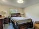 Cozy bedroom with dark wood furniture, including a bed with storage drawers and side tables with lamps at 4073 N Chinook Ln, Ormond Beach, FL 32174