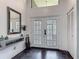 Elegant entryway featuring double doors, high ceilings, tile floors, and decorative mirror at 4073 N Chinook Ln, Ormond Beach, FL 32174