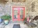 Inviting front entrance with a red double door, stone flooring, and decorative details at 4073 N Chinook Ln, Ormond Beach, FL 32174