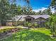 Charming single-story home boasts a well-manicured lawn, lush landscaping, and a brick facade at 4073 N Chinook Ln, Ormond Beach, FL 32174