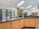 Bright kitchen with skylights, stone fireplace, granite counters, and outdoor views at 4073 N Chinook Ln, Ormond Beach, FL 32174