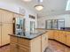 Well-equipped kitchen featuring an island with countertop, stainless steel appliances, and plenty of natural light at 4073 N Chinook Ln, Ormond Beach, FL 32174