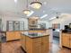 Spacious kitchen with granite countertops, an island, and ample cabinet space with stone fireplace at 4073 N Chinook Ln, Ormond Beach, FL 32174
