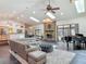 Spacious living room with a stone fireplace, piano, skylights, and an open layout perfect for entertaining at 4073 N Chinook Ln, Ormond Beach, FL 32174