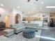 Bright, open living room featuring a large sectional sofa, high ceilings and adjoined kitchen and dining area at 4073 N Chinook Ln, Ormond Beach, FL 32174