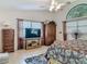 Spacious main bedroom featuring tiled flooring, ceiling fan, large window, and elegant wood furniture at 4073 N Chinook Ln, Ormond Beach, FL 32174