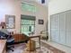 Bright home office with vaulted ceilings, large windows, and functional workspace with a desk and storage at 4073 N Chinook Ln, Ormond Beach, FL 32174