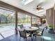 Outdoor patio with ample seating, ceiling fans, skylights, and a view of the pool and spa at 4073 N Chinook Ln, Ormond Beach, FL 32174