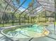 Serene screened-in pool area surrounded by lush greenery, providing a private oasis for relaxation and recreation at 4073 N Chinook Ln, Ormond Beach, FL 32174