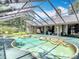 A screened-in pool offers a refreshing escape with ample space for swimming and lounging, with a hot tub at 4073 N Chinook Ln, Ormond Beach, FL 32174