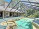 Stunning screened-in pool and spa with views of the home's architecture and outdoor living spaces at 4073 N Chinook Ln, Ormond Beach, FL 32174