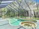 Beautiful screened-in pool with a spa and lush landscaping, perfect for relaxation and enjoyment at 4073 N Chinook Ln, Ormond Beach, FL 32174