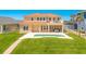 Charming home featuring a pool, lush lawn, and a partial ocean view at 4427 S Atlantic Ave, Port Orange, FL 32127