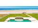 Backyard features a pool, lawn, and beach access, perfect for outdoor entertaining and enjoying the ocean at 4427 S Atlantic Ave, Port Orange, FL 32127
