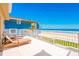 Spacious balcony boasting ocean view, lounge chairs, and white railings overlooking beach at 4427 S Atlantic Ave, Port Orange, FL 32127