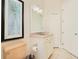 Bathroom with beige fixtures, a vanity with sink, toilet, and white cabinets at 4427 S Atlantic Ave, Port Orange, FL 32127
