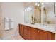 A bathroom featuring double vanity sinks, mirrors, and tub shower at 4427 S Atlantic Ave, Port Orange, FL 32127