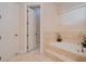 A soaking tub and bathroom with tile accents and neutral colors at 4427 S Atlantic Ave, Port Orange, FL 32127