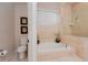 A bathroom featuring a soaking tub, toilet, and a glass-enclosed shower at 4427 S Atlantic Ave, Port Orange, FL 32127
