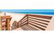 Wooden boardwalk stairs lead down to a pristine white sandy beach and tranquil turquoise waters at 4427 S Atlantic Ave, Port Orange, FL 32127