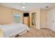 Bedroom with ensuite bath, complemented by neutral decor and a tv at 4427 S Atlantic Ave, Port Orange, FL 32127